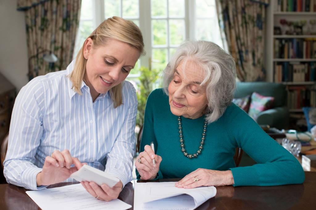 Caregiver-Elderly-Woman-Reviewing-Taxes