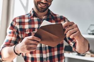 Guy-Opening--Greeting-Card-Smiling