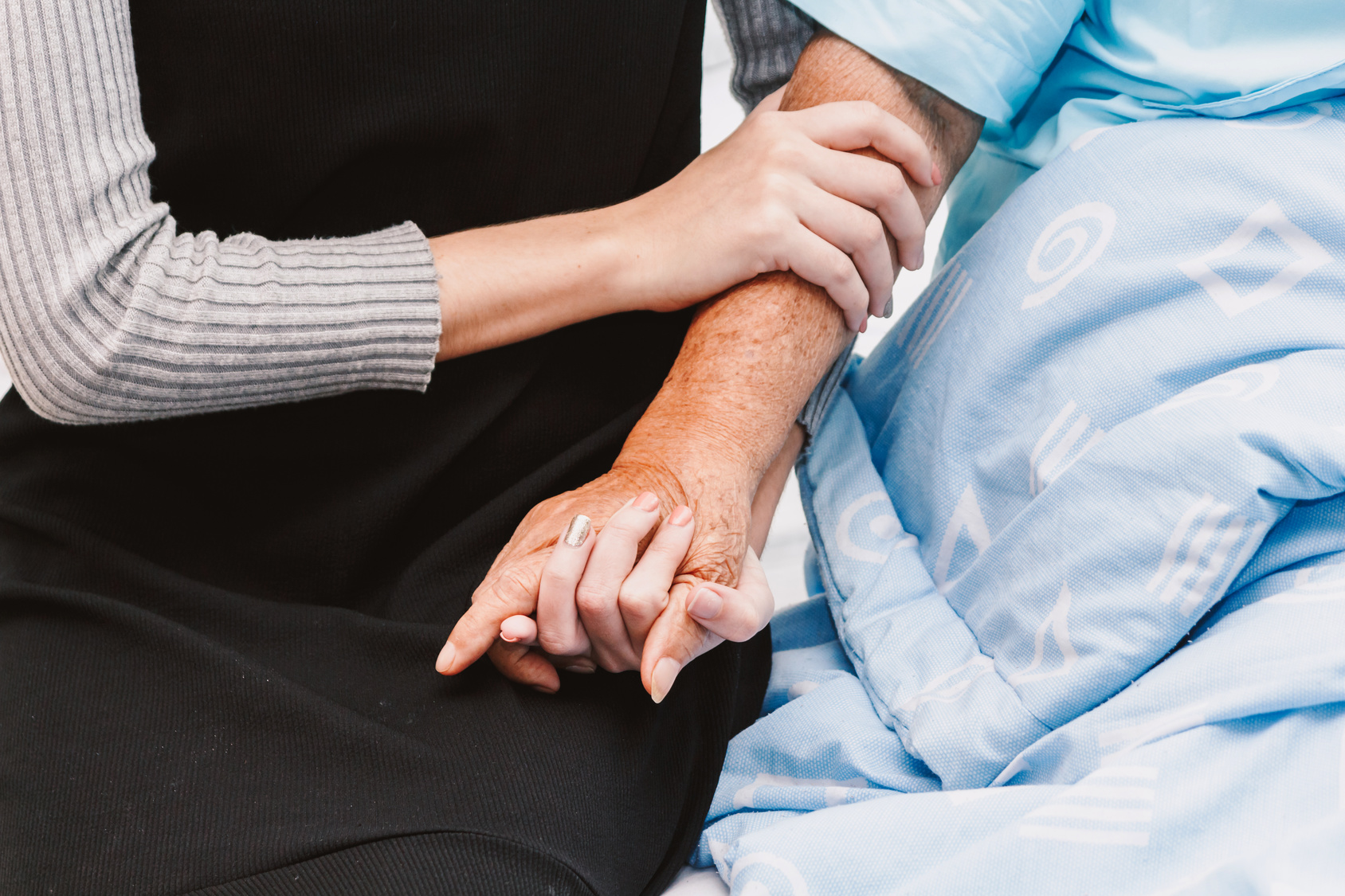 Caregiver-Holding-Senior's-Hands