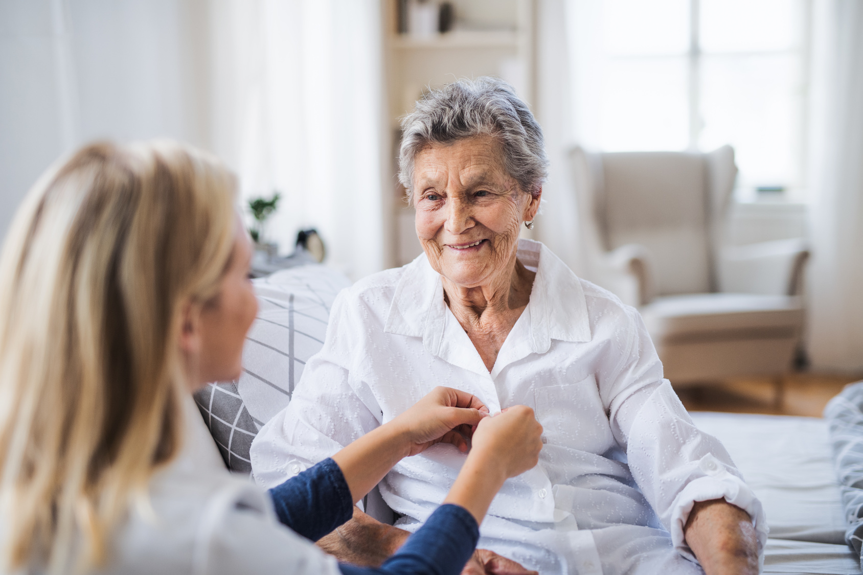 Caregiver-Dressing-Elderly-Woman