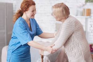 Caregiver helping senior to walk Elderly-Care-in-Elk-Grove-Village-IL