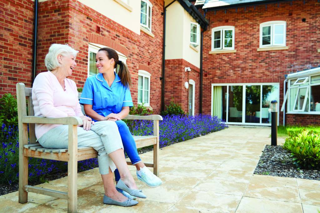 Caregiver and Senior Laughing