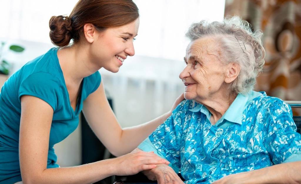 Caregiver Smiling and Meeting Senior Caregiver Smiling and Meeting Senior