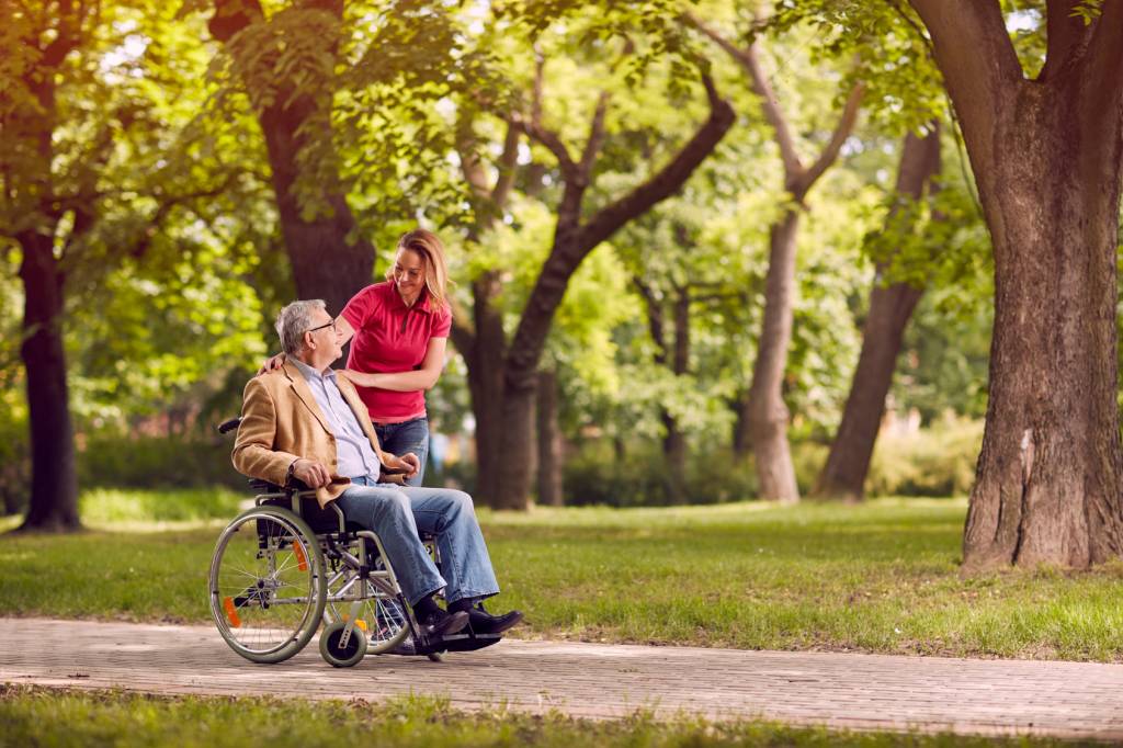 Caregiver Assisting Man in Wheelchair