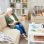 Elderly reading with a pet