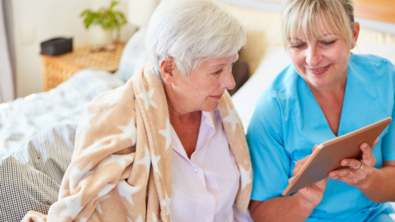 Senior discussing care plan with caregiver