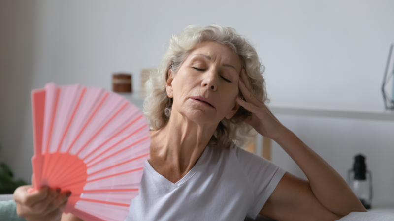 Elderly cooling down with a fan