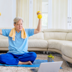 Senior exercising at home using a computer