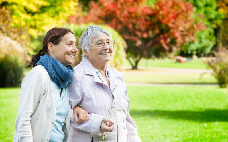 Senior and caregiver walking together