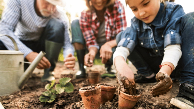 Senior and family gardening in the yard